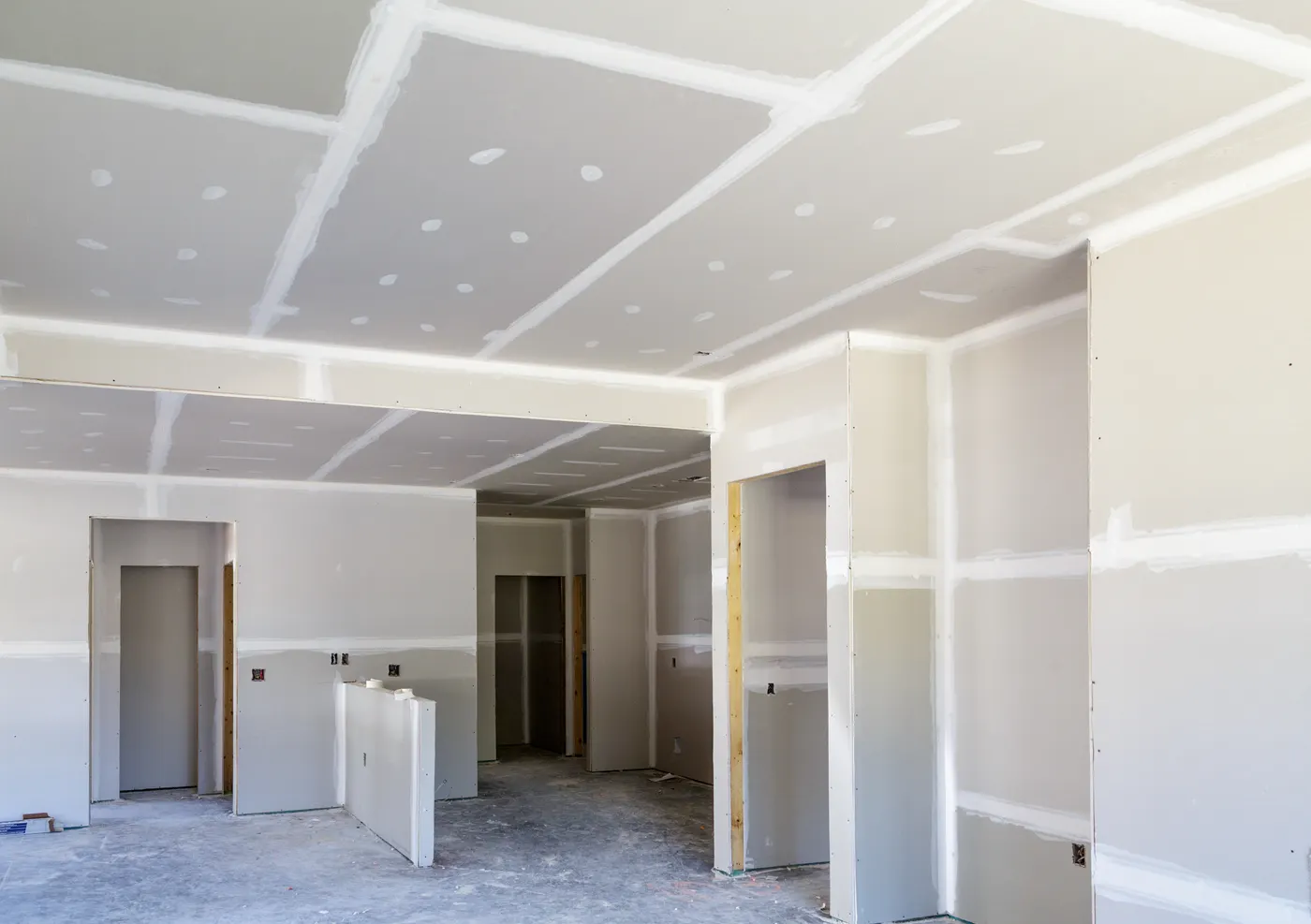 A home interior at the drywall stage of a full remodel