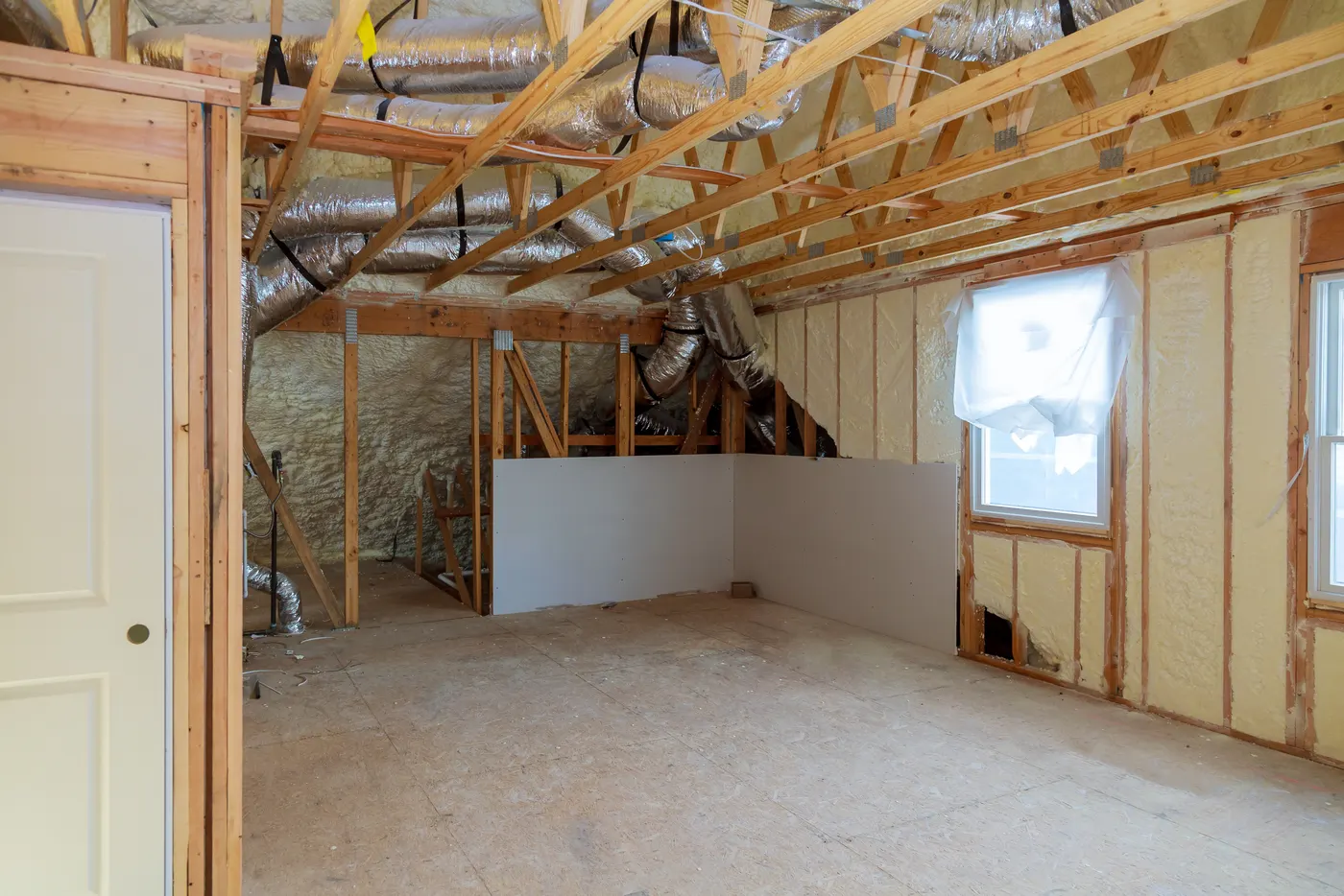 A framed and insulated room partway through a remodel