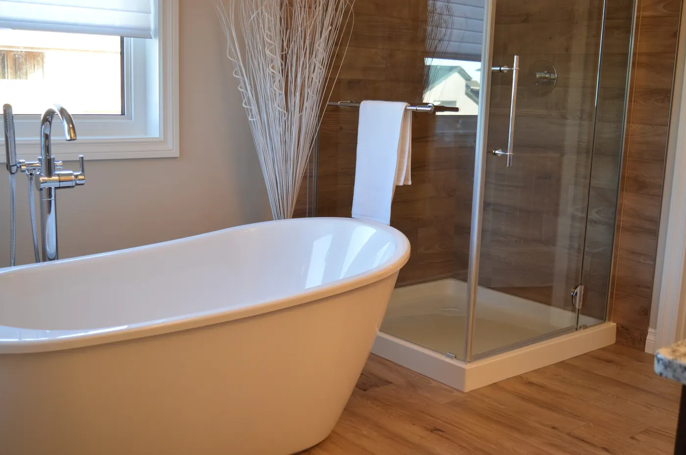 A bathroom with a freestanding tub and a glass walk-in shower