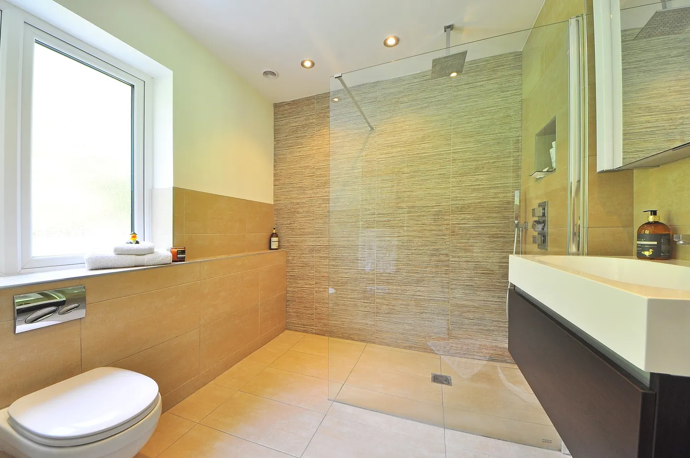A fully tiled walk-in shower and bathroom floor